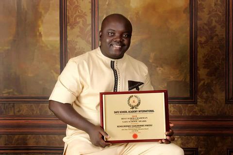 Kenechukwu Nwosu holding the Safe School Award certificate