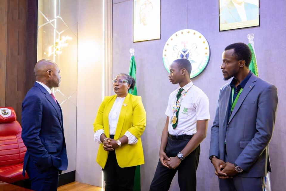 Officials meeting with a student and teachers, July 2026